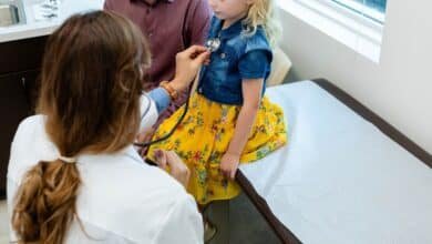 Photo: A doctor reviews a child in an office in a file photo without date.