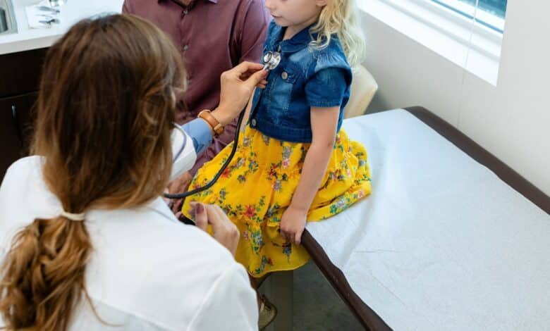 Photo: A doctor reviews a child in an office in a file photo without date.