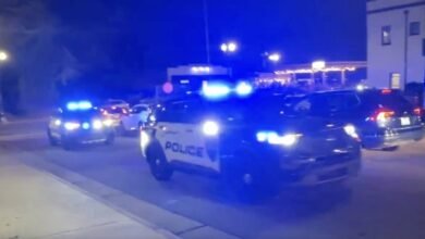 PHOTO: Several police vehicles sound sirens after reports of shots fired at Christmas Tree Lighting in Concord, North Carolina.