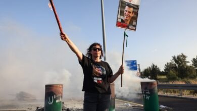 PHOTO: A woman holds a sign with a photograph of Israeli hostage Dror Or on April 19, 2024, during a protest calling for his release.