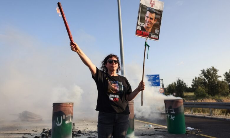 PHOTO: A woman holds a sign with a photograph of Israeli hostage Dror Or on April 19, 2024, during a protest calling for his release.