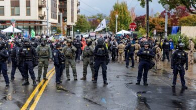 PHOTO: People participate in a protest organized by Portland Against Deportations at the ICE facility in Portland