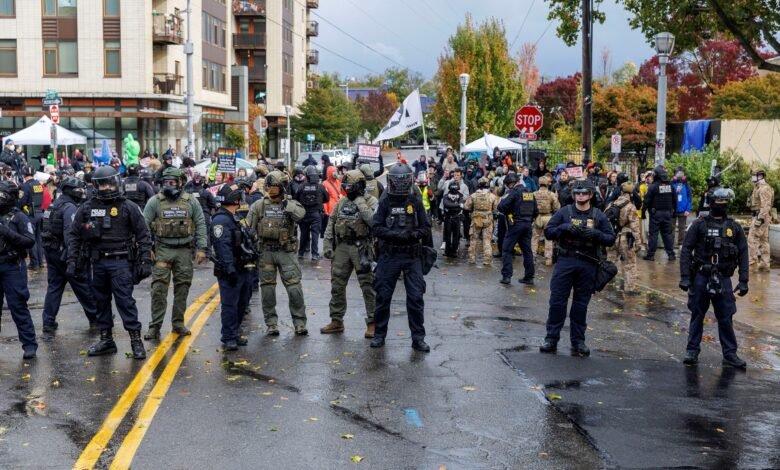 PHOTO: People participate in a protest organized by Portland Against Deportations at the ICE facility in Portland