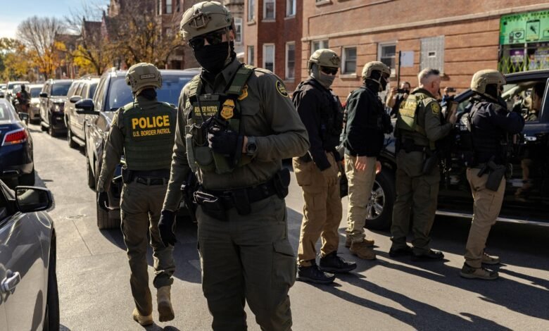 PHOTO: Federal agents confront community members during immigration raids